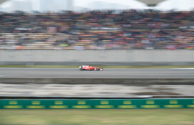 A dynamic snapshot of a Formula 1 car zooming past the finish line with a digital leaderboard overlay showing friends’ predictions.