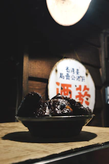 A vibrant display of J&M Night Bites' signature dishes arranged on a rustic wooden table under warm lighting.
