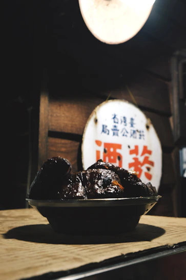 A vibrant display of J&M Night Bites' signature dishes arranged on a rustic wooden table under warm lighting.