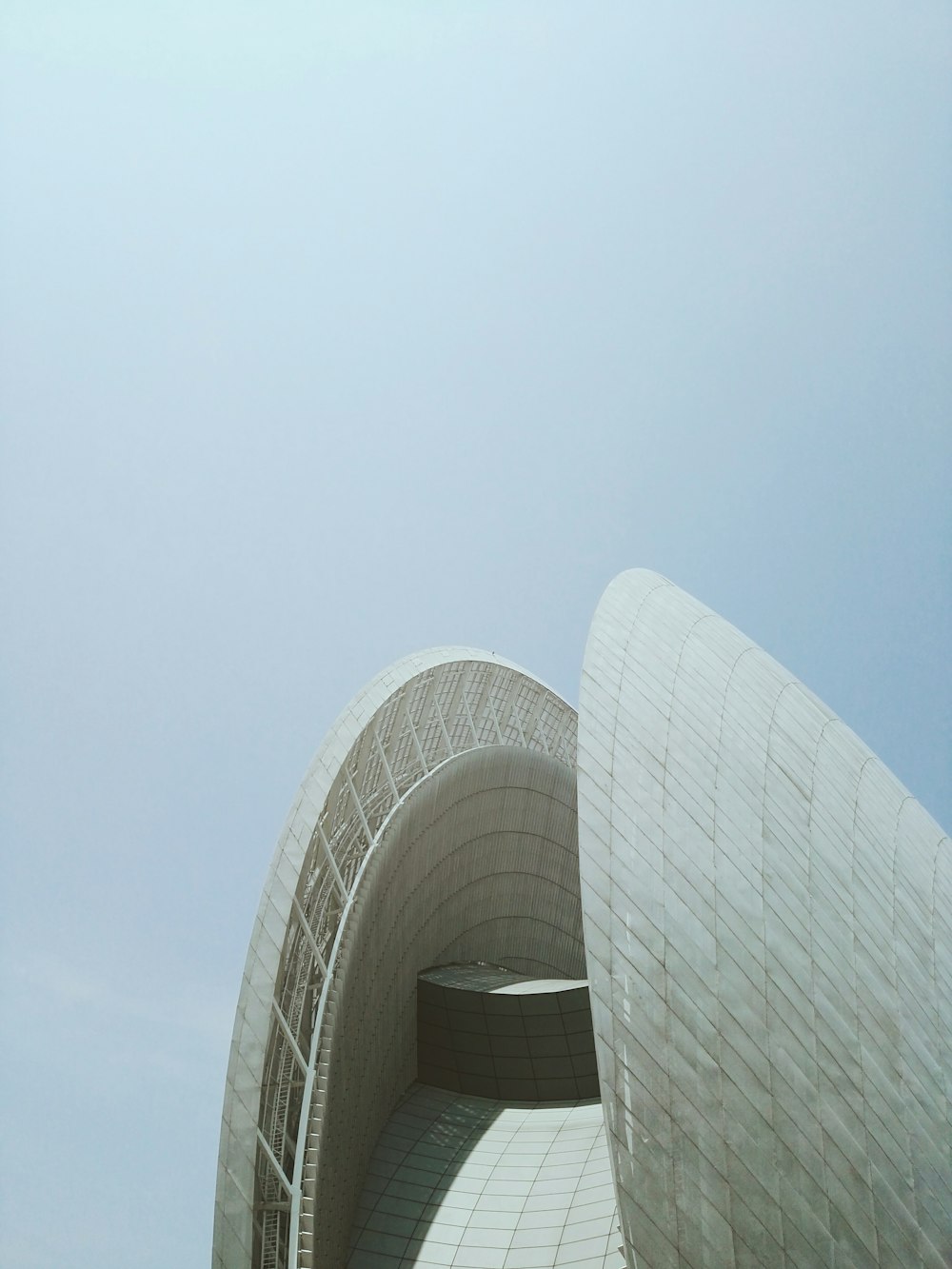 concrete building under white clouds