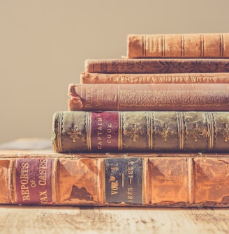 shallow focus photography of stack of books