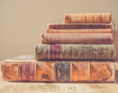 shallow focus photography of stack of books
