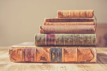 shallow focus photography of stack of books