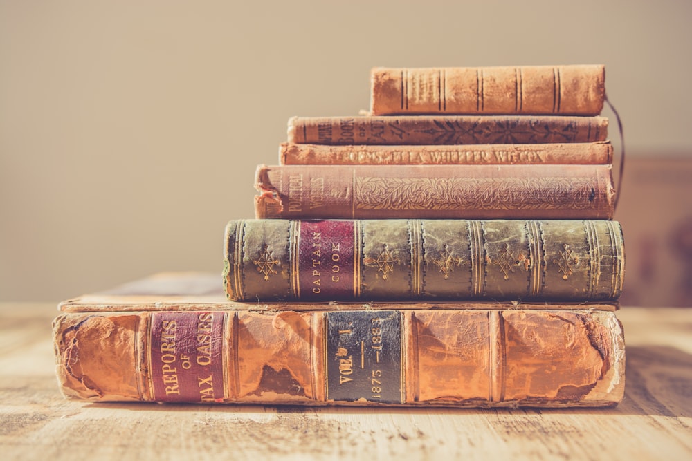 shallow focus photography of stack of books