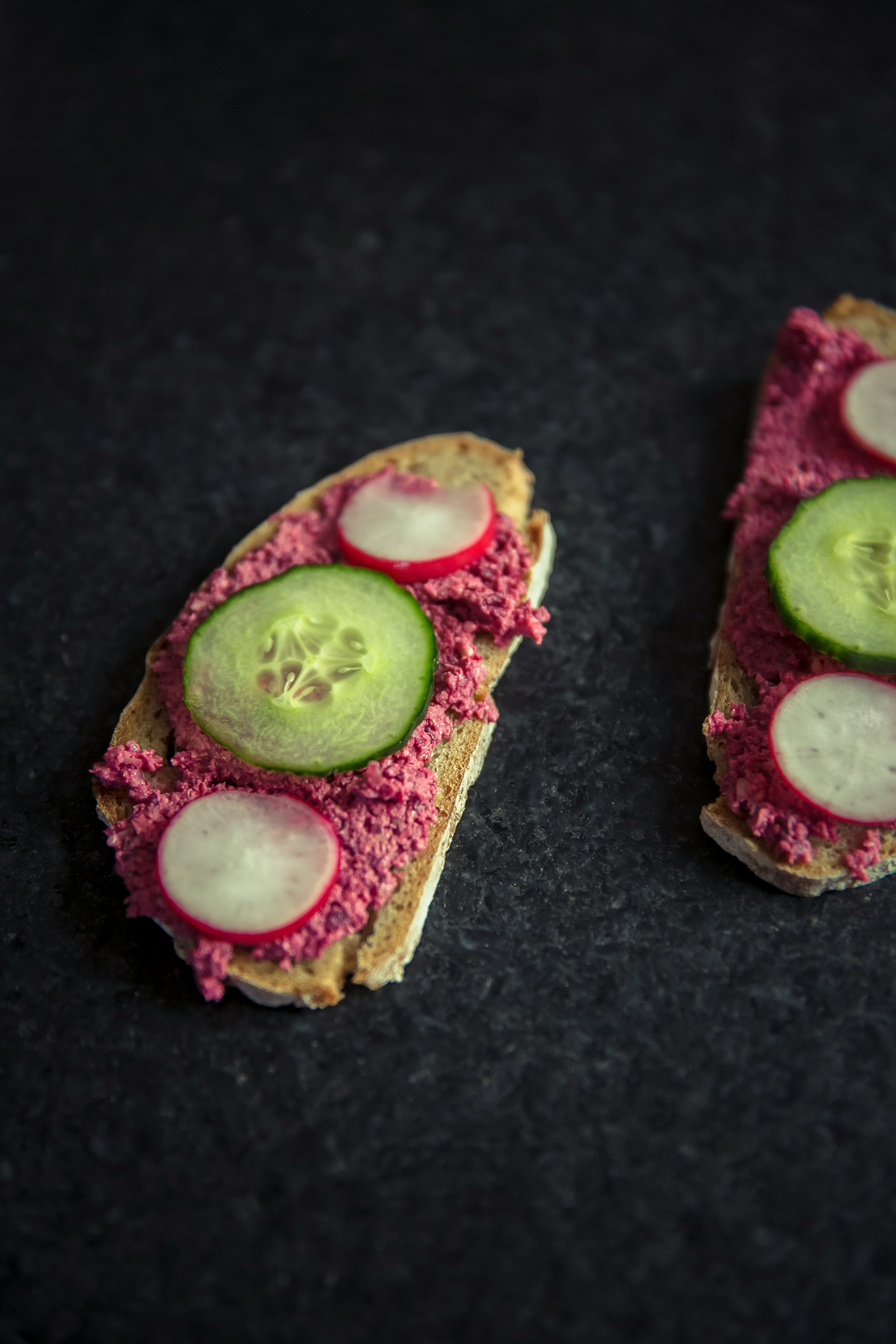 bread with sliced dragon fruit and cucumber on top