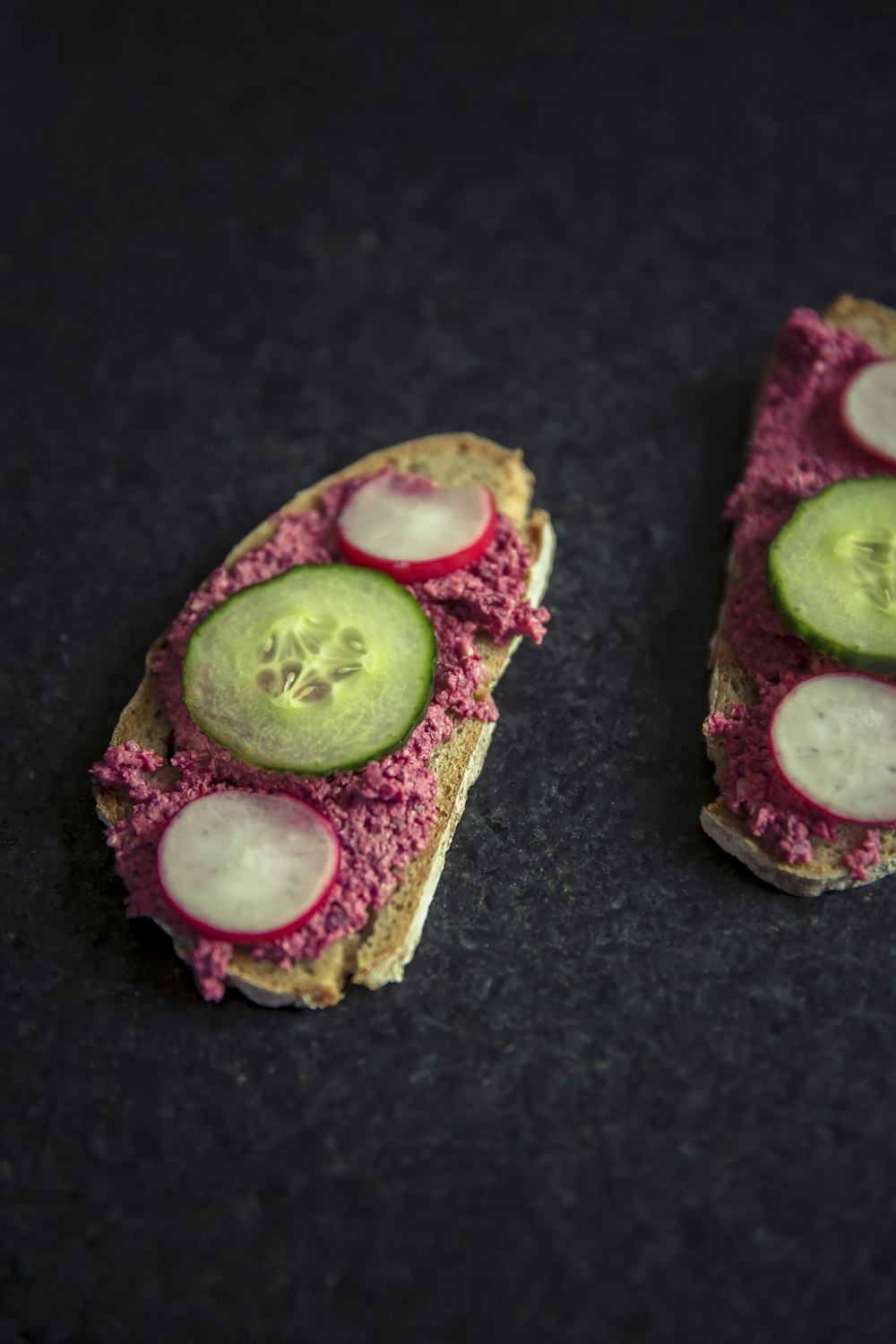 bread with sliced dragon fruit and cucumber on top