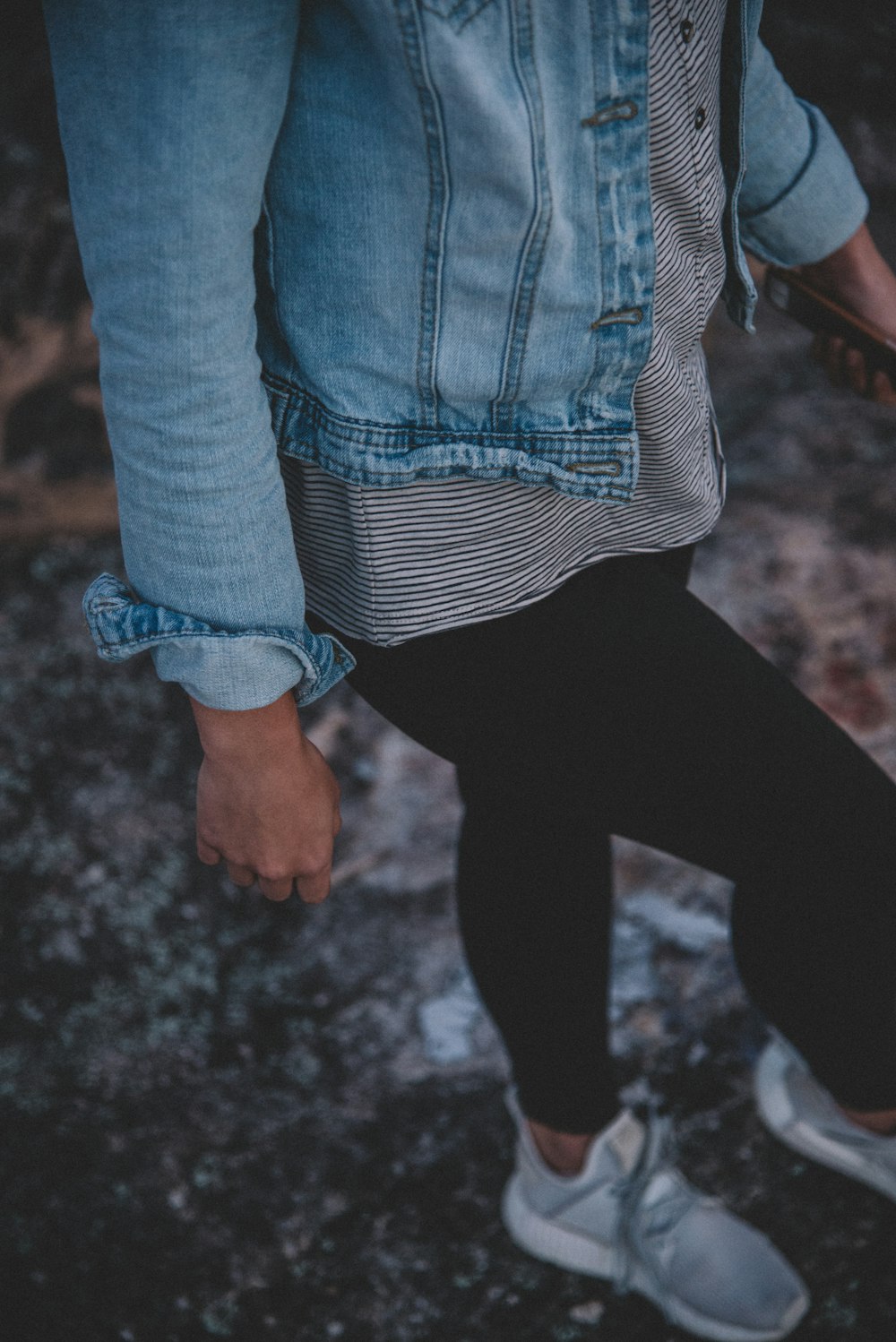 woman in black leggings walking on gray concrete floor