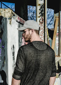 Photo featuring gray Azor caps in an urban graffiti environment.