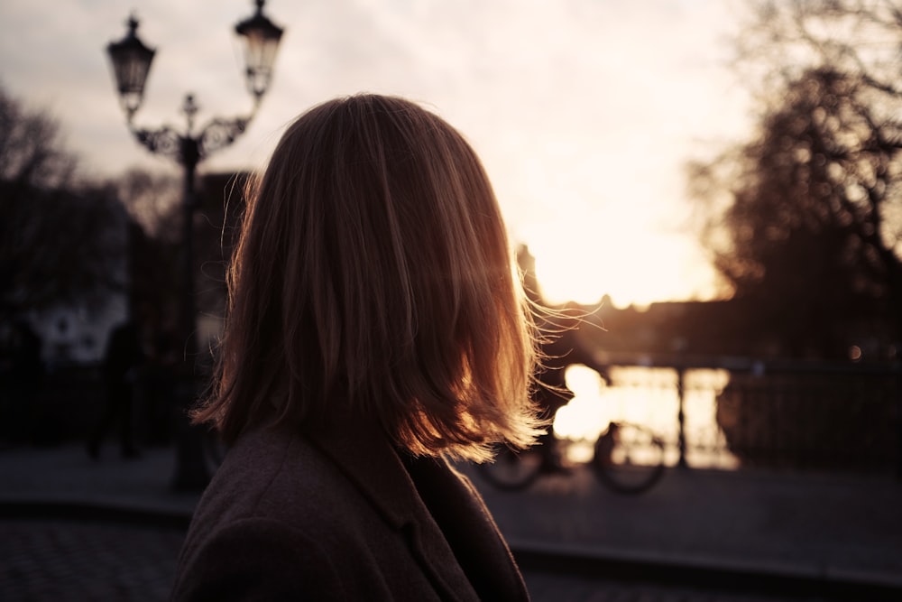 selective focus photography of woman wearing grey notched lapel suit jacket