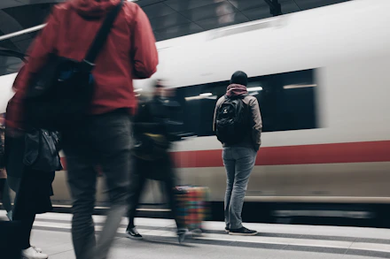 people standing beside train