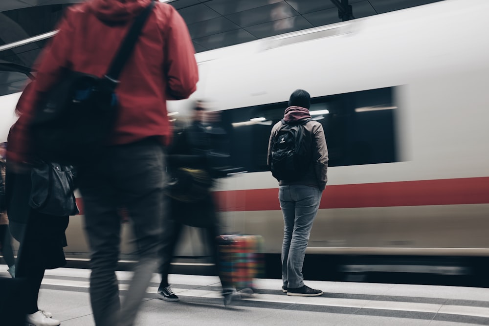 people standing beside train