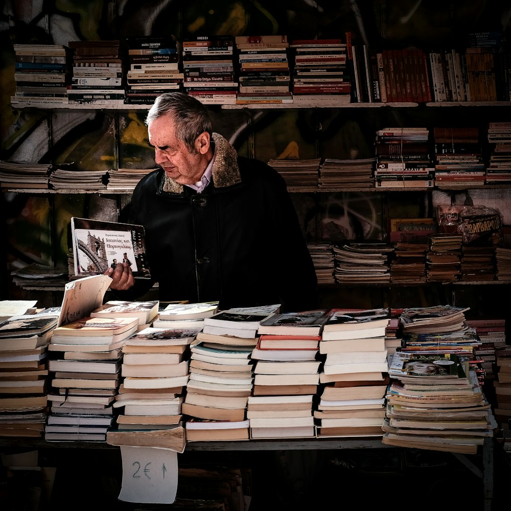 man looking at books