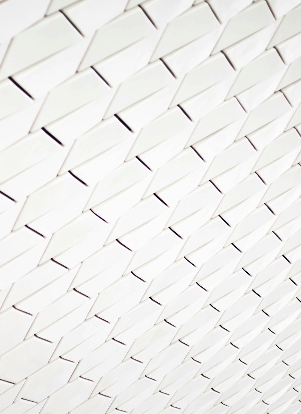 A pattern of white geometric shapes in a facade