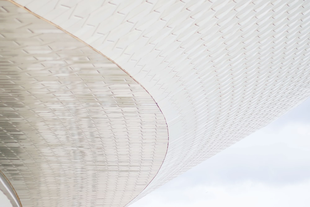 A view of white patterned architecture from below.