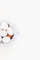 Close-up of freshly laid eggs in a rustic basket.