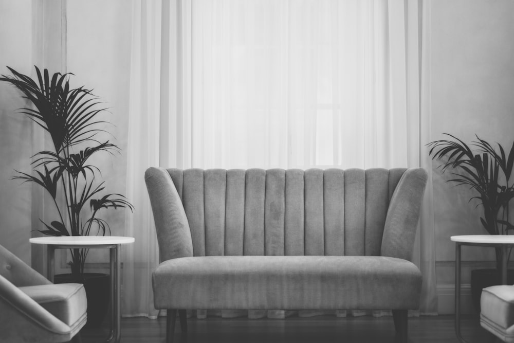 grey couch near white window curtain during daytime