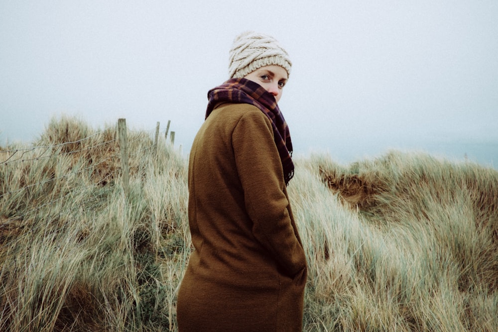 woman standing on grass during daytime