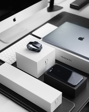 A sleek, modern workspace featuring a lineup of refurbished iPhones on display.