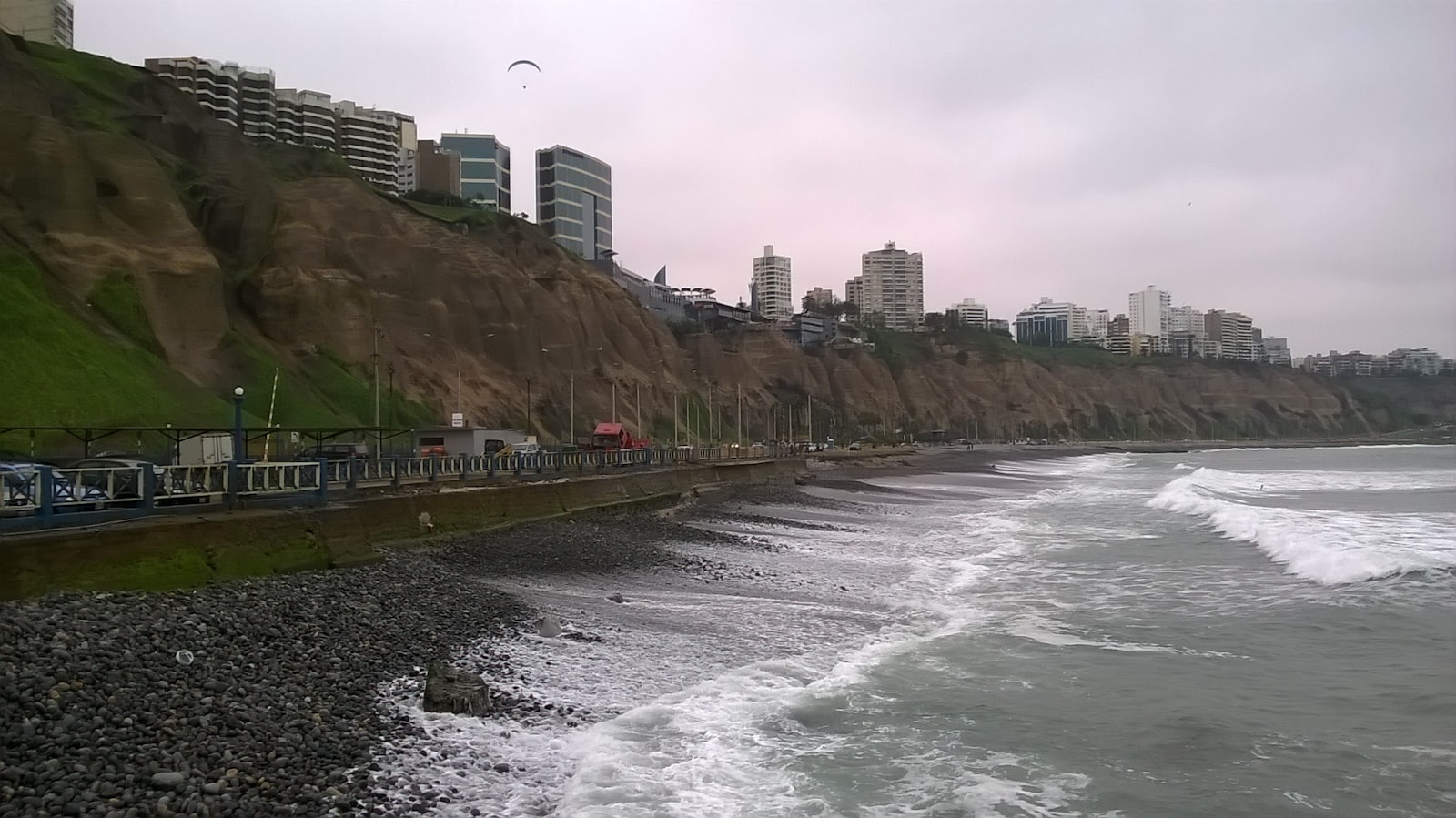 Overcast afternoon along the Miraflores boardwalk and Costa Verde cliffs in Lima, Peru