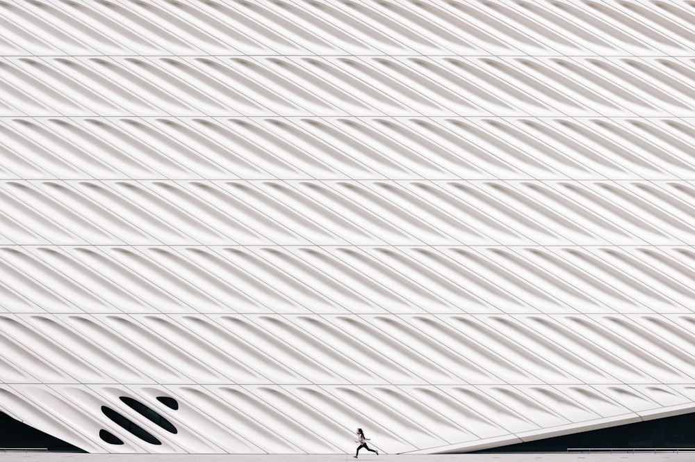 person running near white painted wall