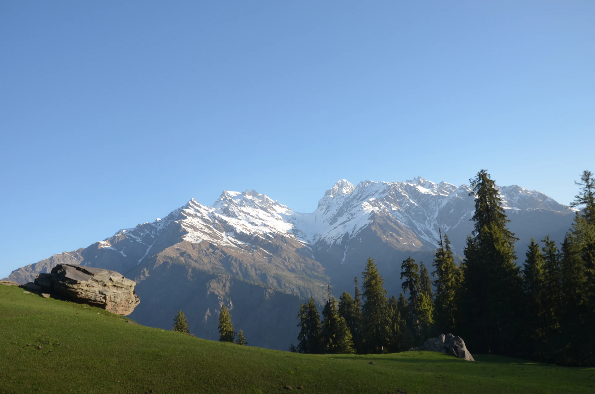 white and green mountain and gray rock near green trees