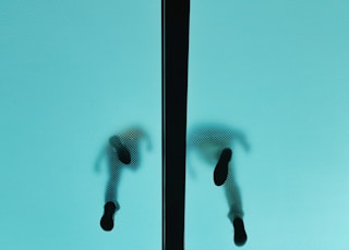 low angle photography of two people walked in glass flooring