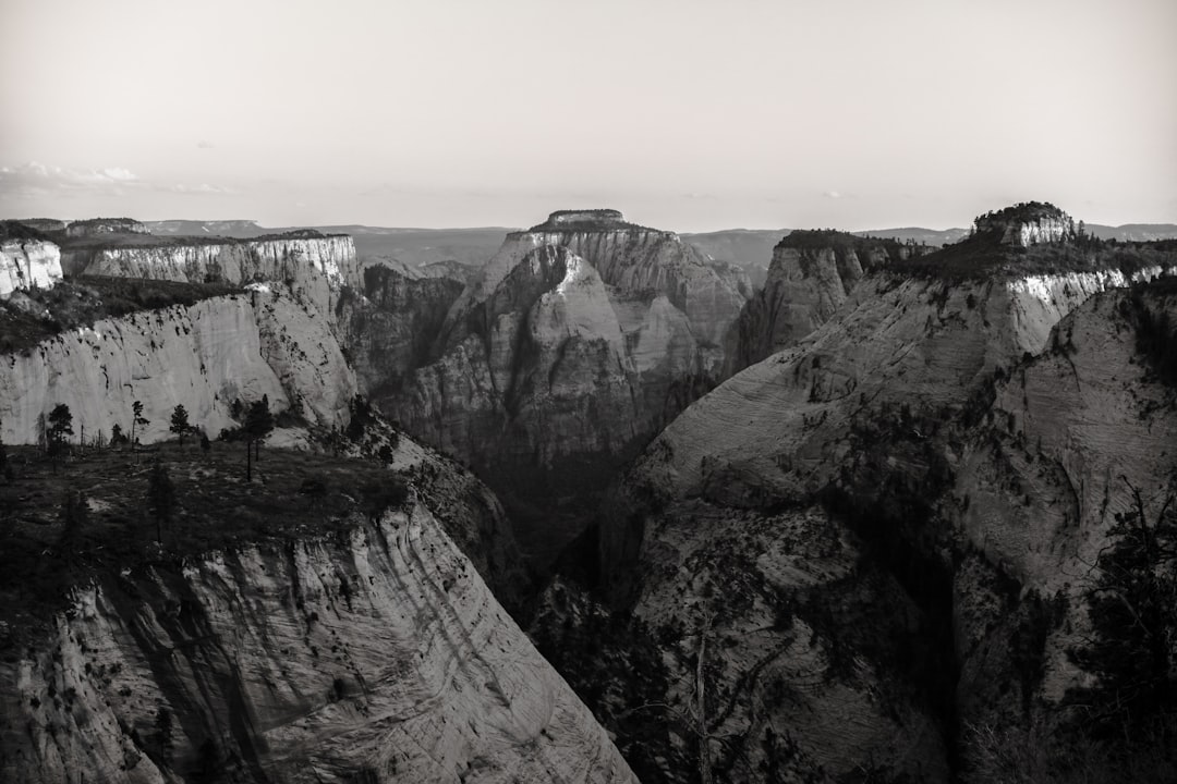 person standing on rocky mountain during daytime