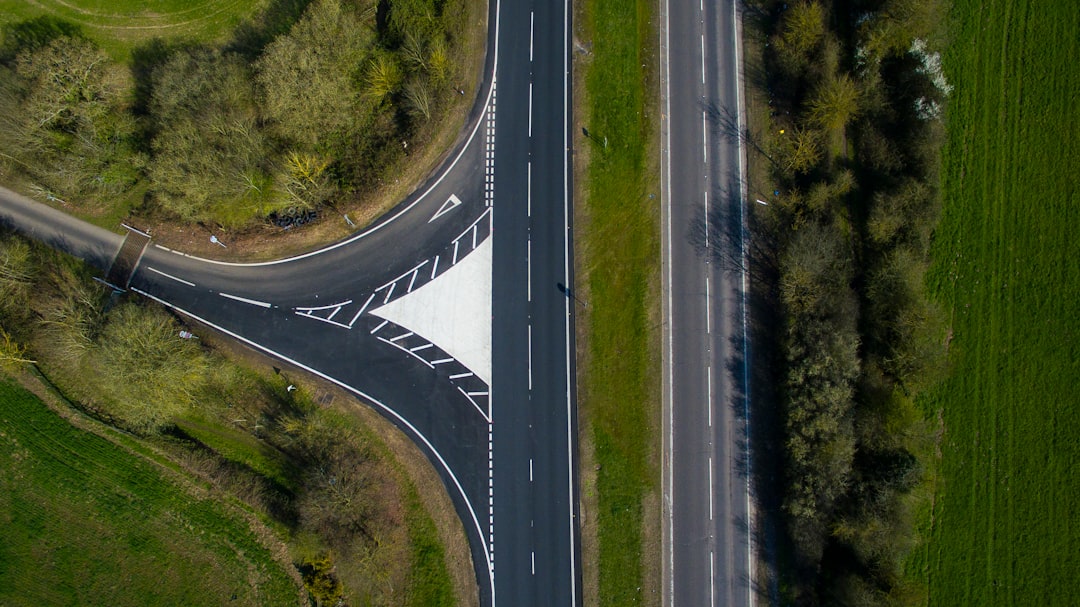 aerial view of gray concrete road near trees