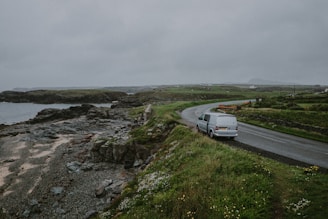 white van parked besides concrete road