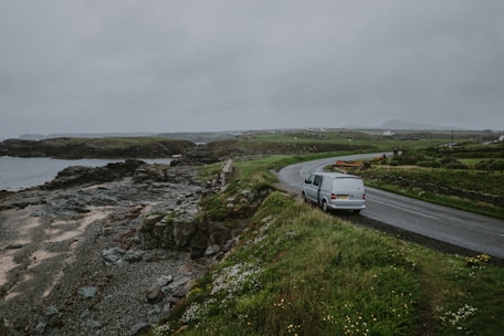 white van parked besides concrete road