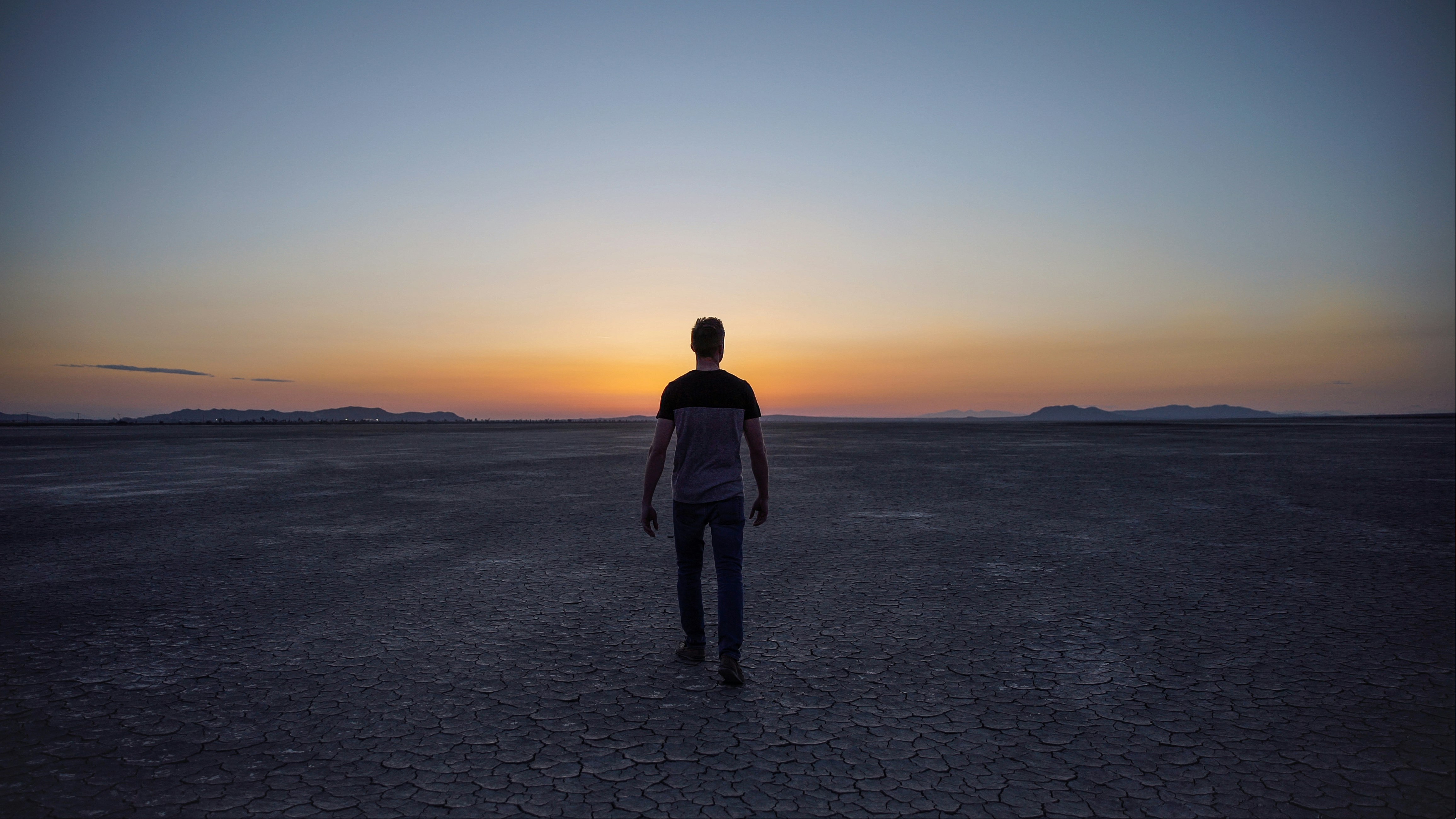 man walking on desert