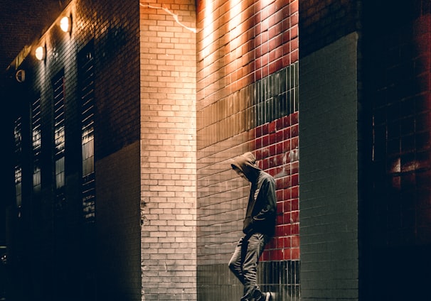 man learning on concrete wall