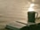 green ceramic mug beside book