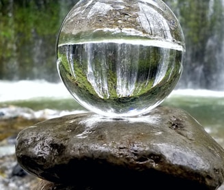 clear glass ball on brown rock