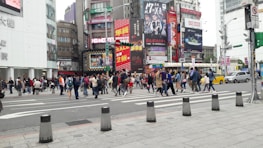 A busy urban intersection with multiple Uber cars displaying different brand advertisements.