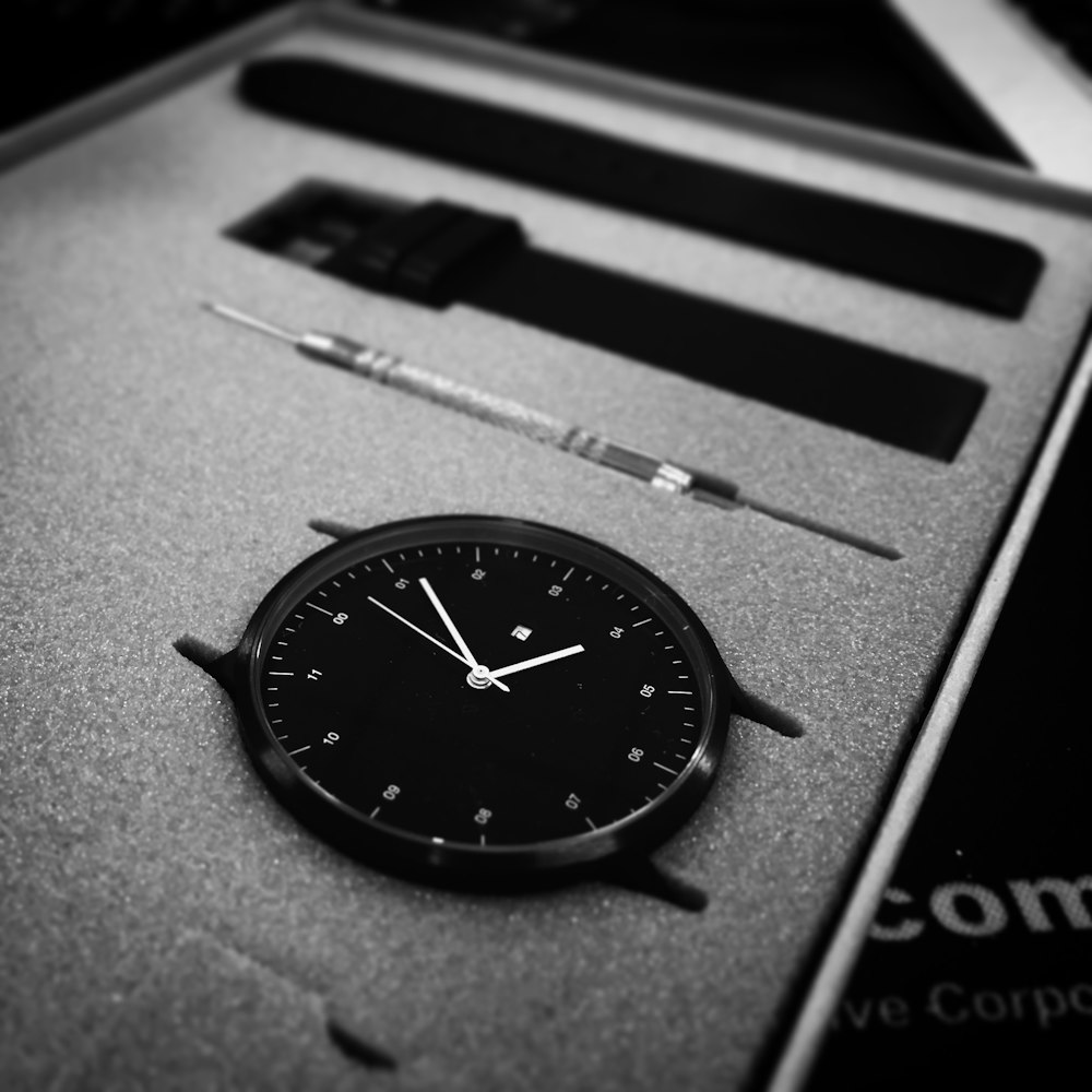 black analog watch in black box