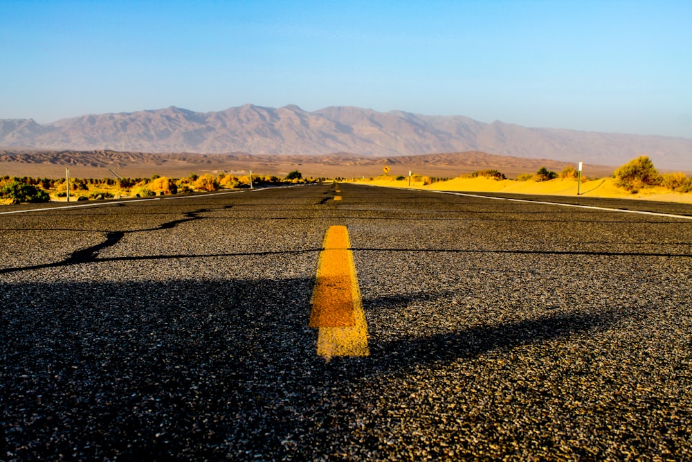 photography of black and yellow concrete road