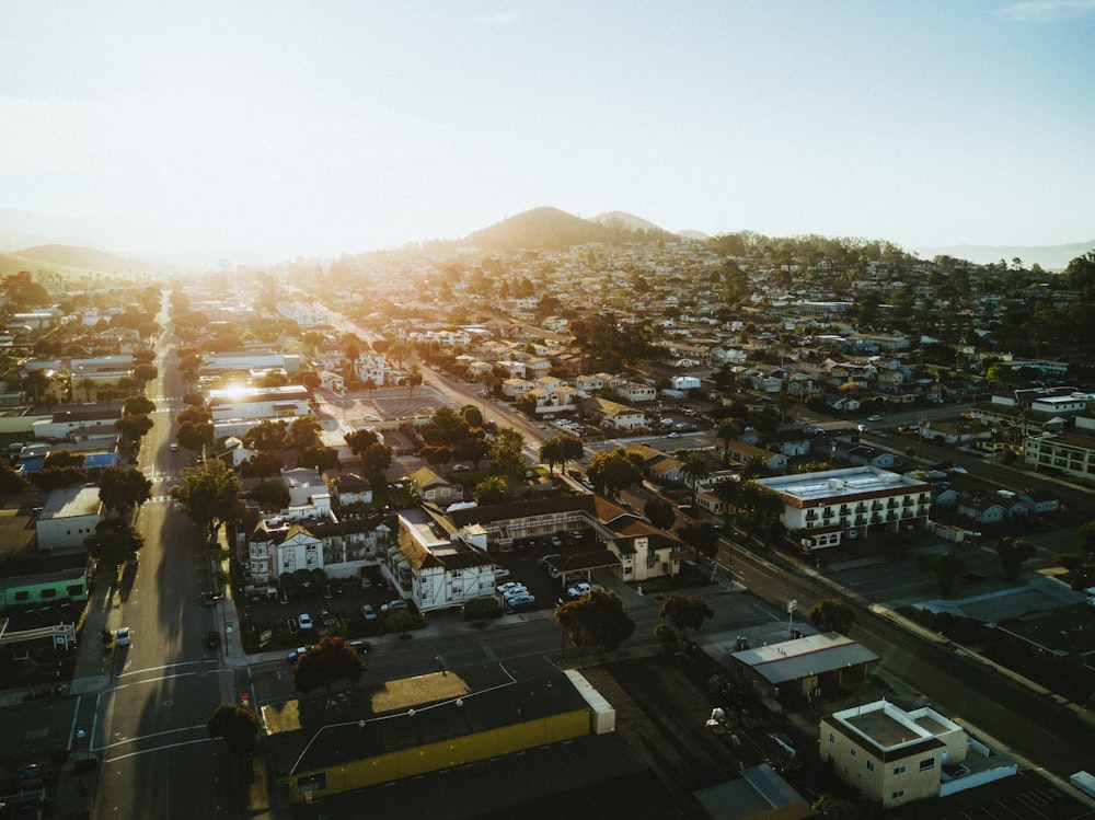 high-angle photography of commercial buildings and houses during orange sunset