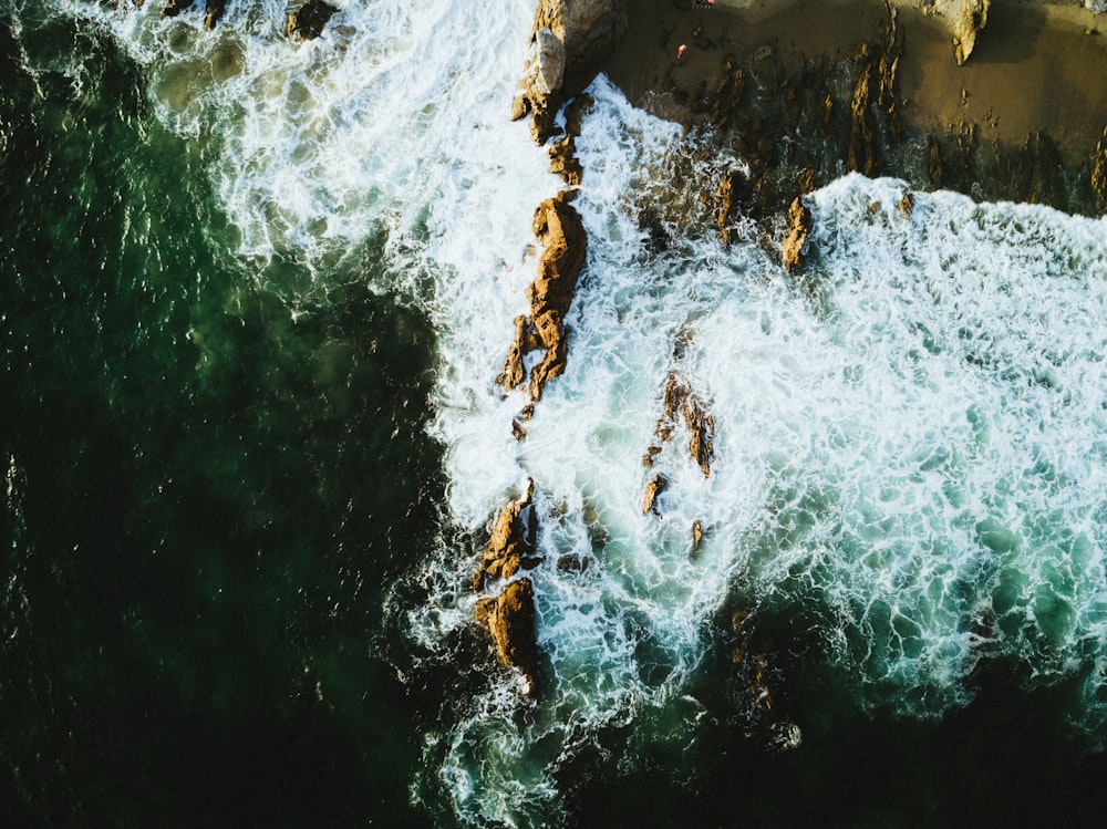 aerial photo of rock formation surrounded by body of water