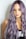 purple haired woman in black top leaning on wall