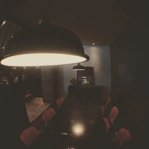 Guests enjoying a relaxed dinner in a softly lit, retro-style dining room