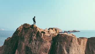 man stands on top of mountain