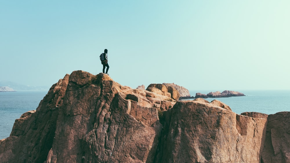 man stands on top of mountain