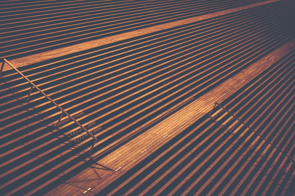 Multiple stairs with a single handrail and shadows