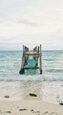 An old wooden pier extending into a tranquil bay.