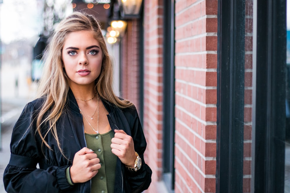 woman standing beside wall