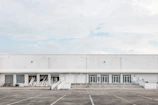 A large industrial cold storage facility with blue and white exterior under clear sky