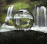 water falling from clear glass ball