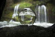 water falling from clear glass ball