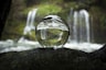 water falling from clear glass ball